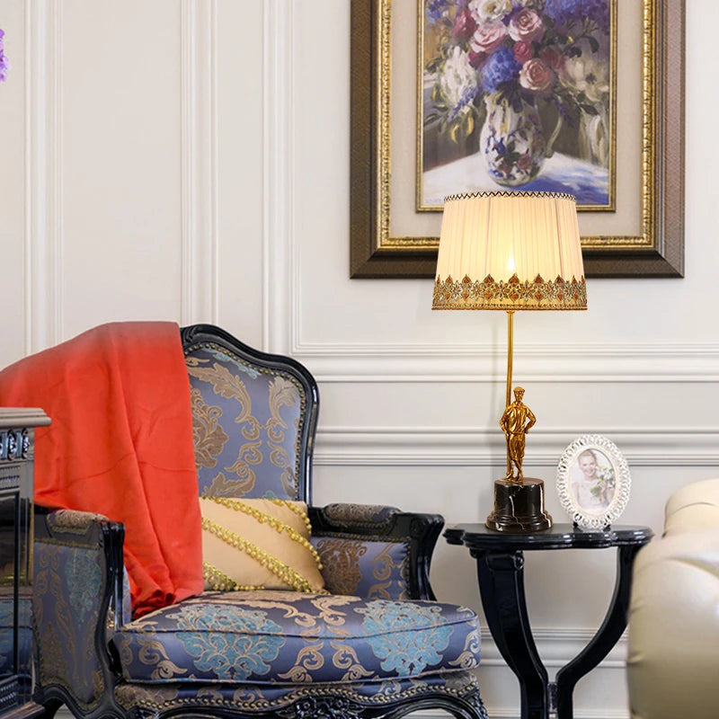 "Golden statue base table lamp with elegant fabric shade – luxury home décor lighting in Saudi Arabia"